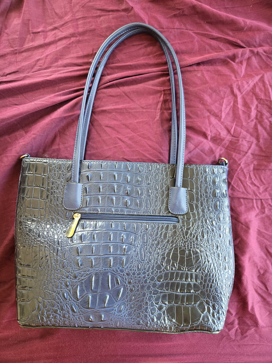 Faux snakeskin blue purse with red inside.